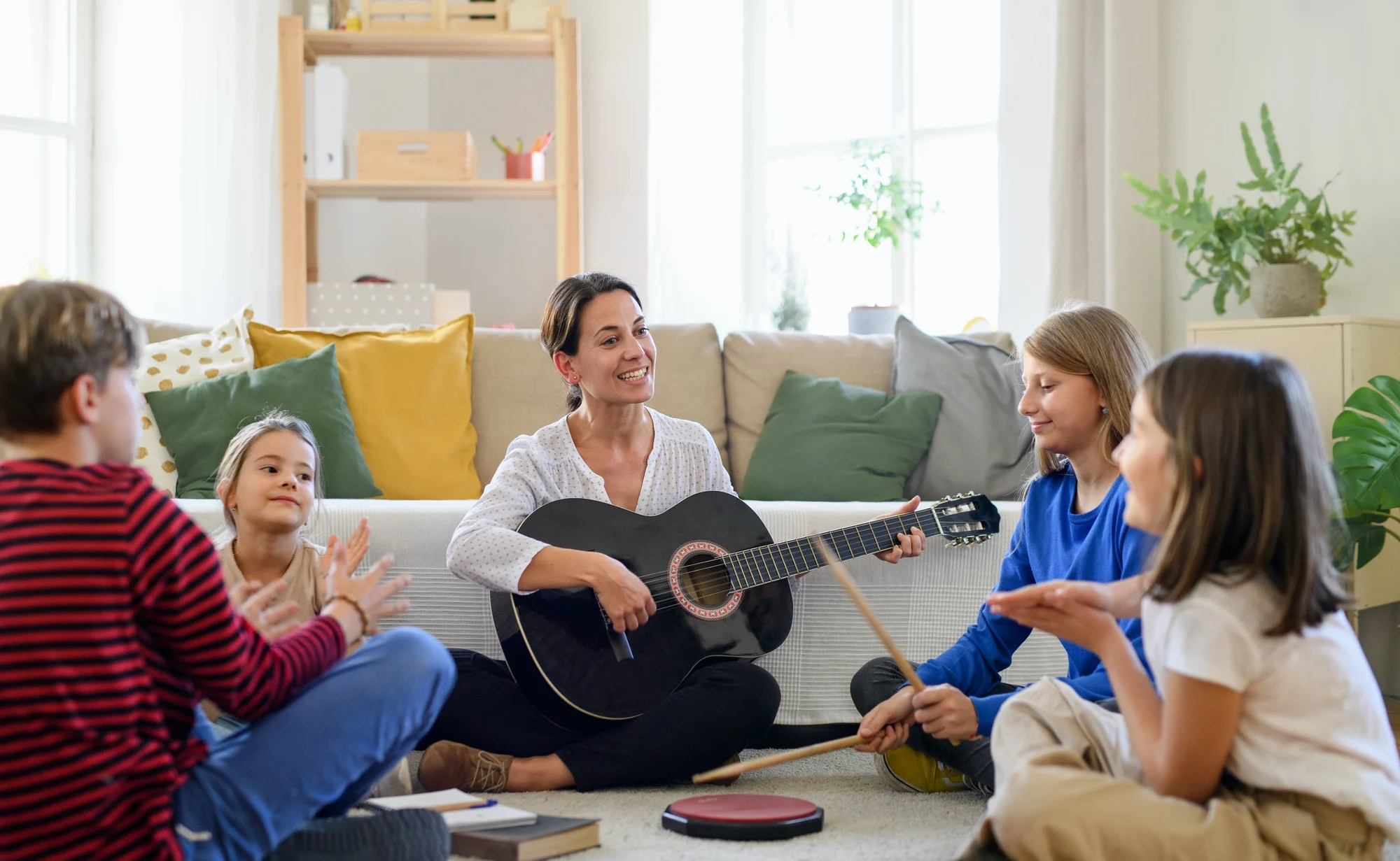 group-of-homeschooling-children-with-teacher-having-music-lesson-indoors-coronavirus-concept-1-1.webp